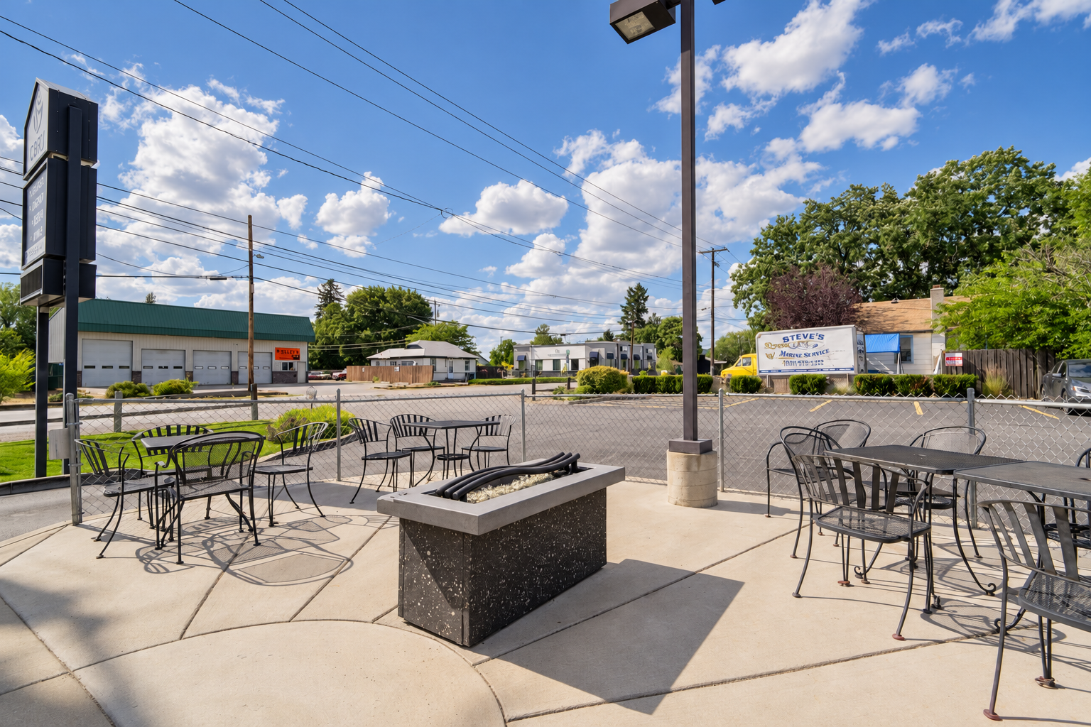 Cozy Coffee patio with metal tables, chairs and a gas fire pit